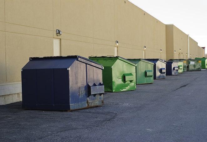 a group of construction workers taking a break near a dumpster in Brockton